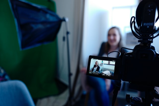 A women promoting her website by recording a YouTube video interview.